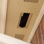 A hole in the ceiling of an apartment building.